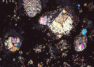 Thin section of the Allende meteorite showing a carbon-rich matrix around the chondrules