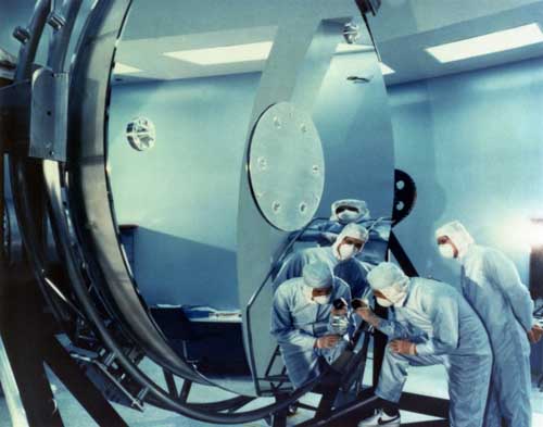Images of NASA technicians in Hubble's main mirror