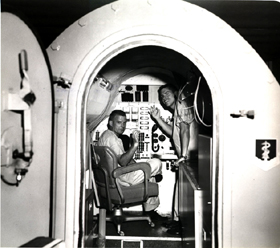 Air Force personnel performing experiments in the Two-Man Simulator at the School of Aerospace Medicine, circa 1965