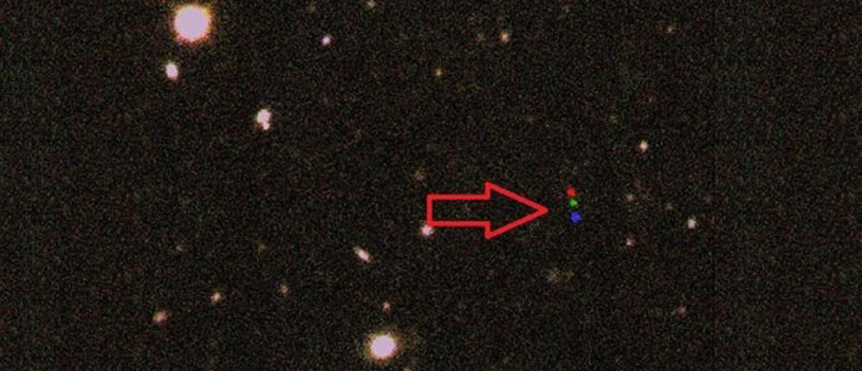 Three images, showing dwarf planet 2012 VP113 in red, then green, then blue, were combined to reveal its path across the night sky.