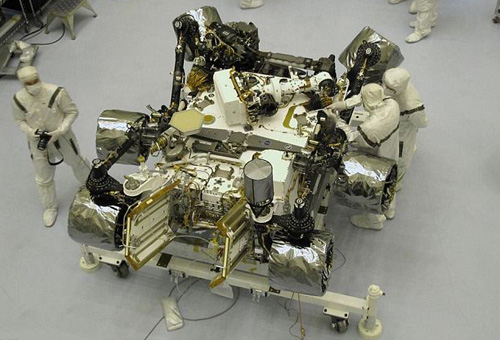 The Curiosity rover under going final preparations and being checked out by technicians