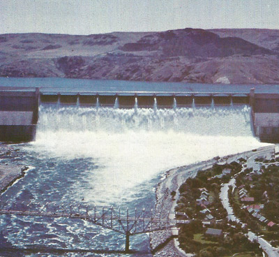 A dam holds water at a height and when the water is released its potential energy changes to kinetic energy that can be converted into useful electrical energy by water turbine generators.