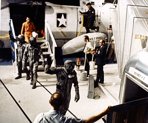 Apollo 11 astronauts leave the recovery helicopter after returning from the Moon