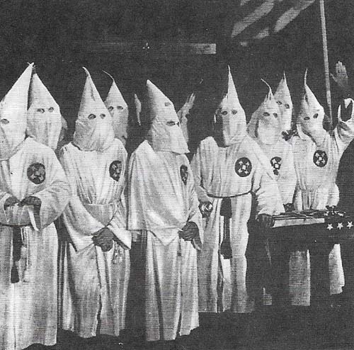 Members of the Ku-Klux-Klan, hooded and robed, hold elaborate initiation ceremonies.