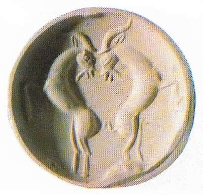 This seal, in reality only 1.5 cm (0.6 in) across, demonstrates the mastery of Minoan carvers. It is in blue chalcedony. 