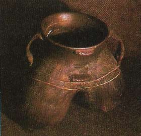 This black pottery tripod vessel is known as a li.