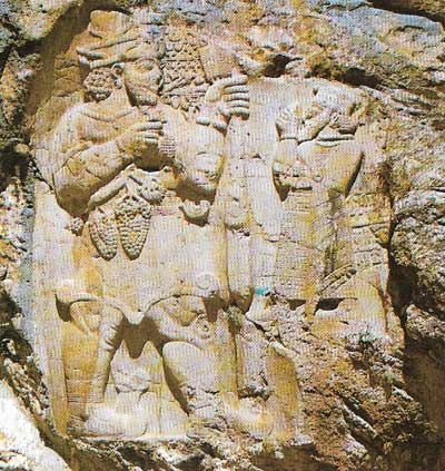 The rock carving at Wiz in the Taurus Mountains exemplifies the Aramaean style in Hittite sculpture, as is shown in particular by the god's cap and by the ringlets and profiles of both figures.