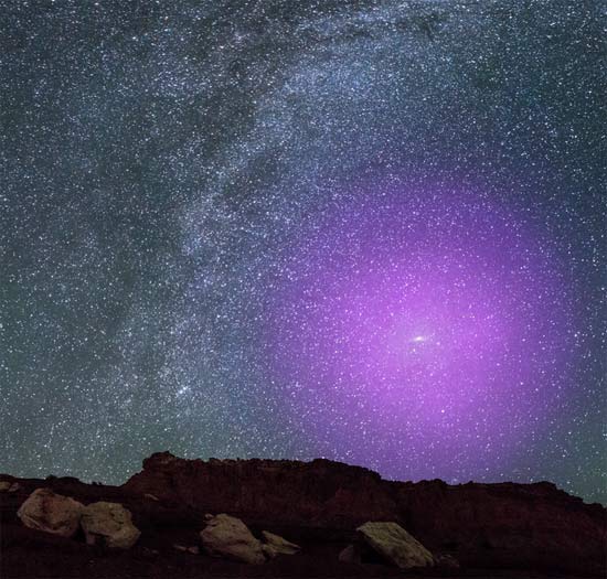 At a distance of 2.5 million light-years, the Andromeda galaxy it is so close to us that it appears as a cigar-shaped smudge of light high in the autumn sky. If its gaseous halo could be seen with the naked eye, it would be about three times the width of the Big Dipper — easily the biggest feature on the nighttime sky.