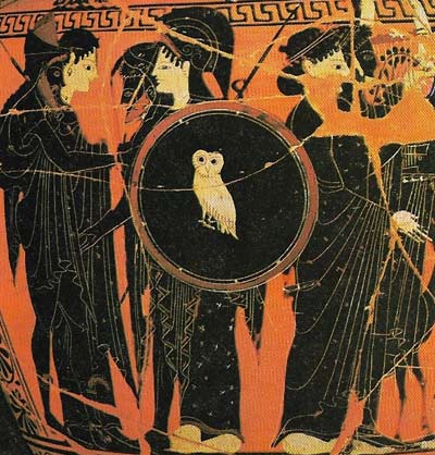 Gods and goddesses with Athena holding a shield inscribed with an owl are shown on this Greek vase.