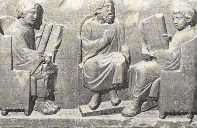 This sandstone relief from Gaul shows a school scene: a teacher is seated between his two pupils who are opening their scrolls for the lesson.