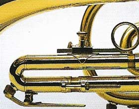 A trumpet has three piston valves and two finger grips.