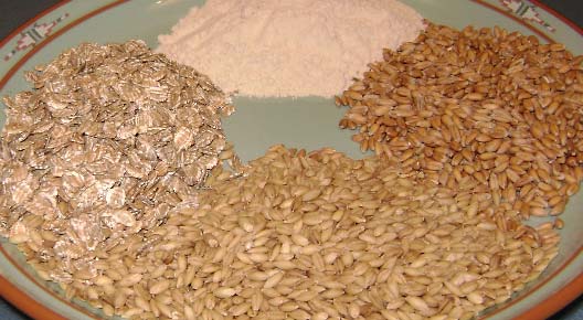 Examples of sources of gluten (clockwise from top): wheat as flour, spelt, barley, and rye as rolled flakes.