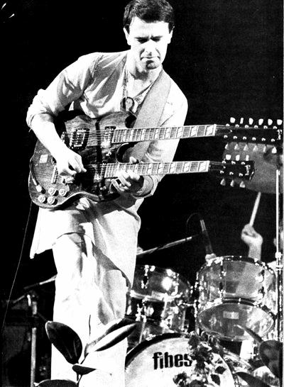 John McLaughlin playing a double-neck guitar