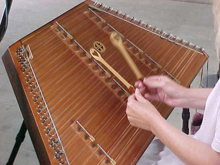 Playing a hammered dulcimer